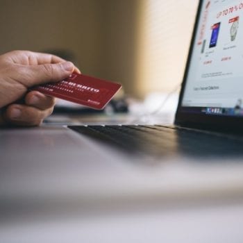 person online shopping and holding credit card