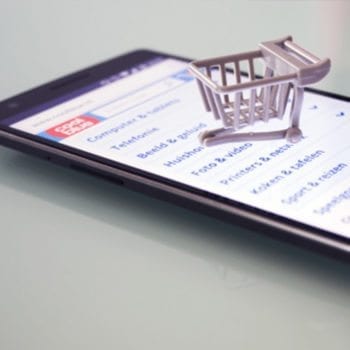 plastic shopping cart on top of mobile device