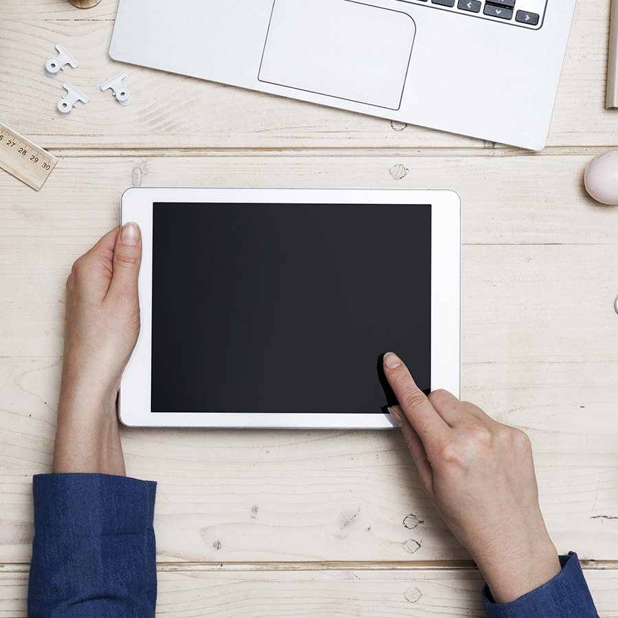 Person using a white iPad