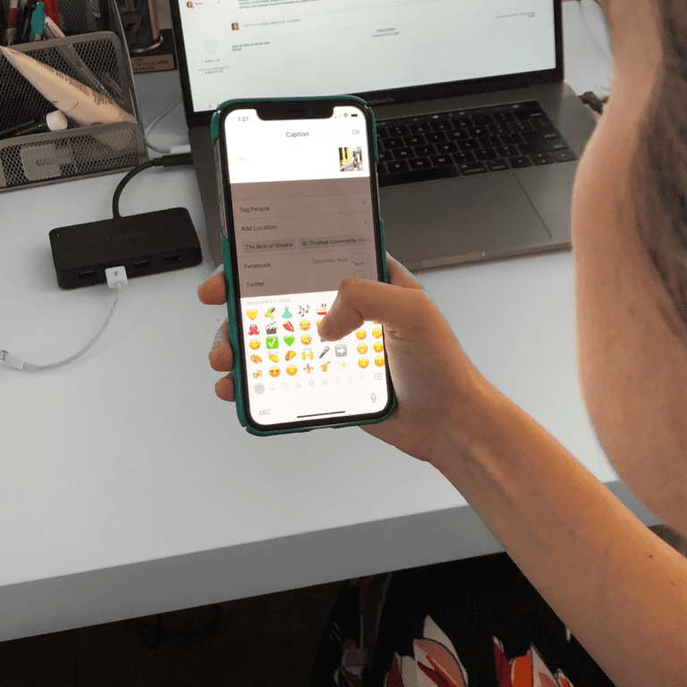 Woman selecting emoji from keyboard