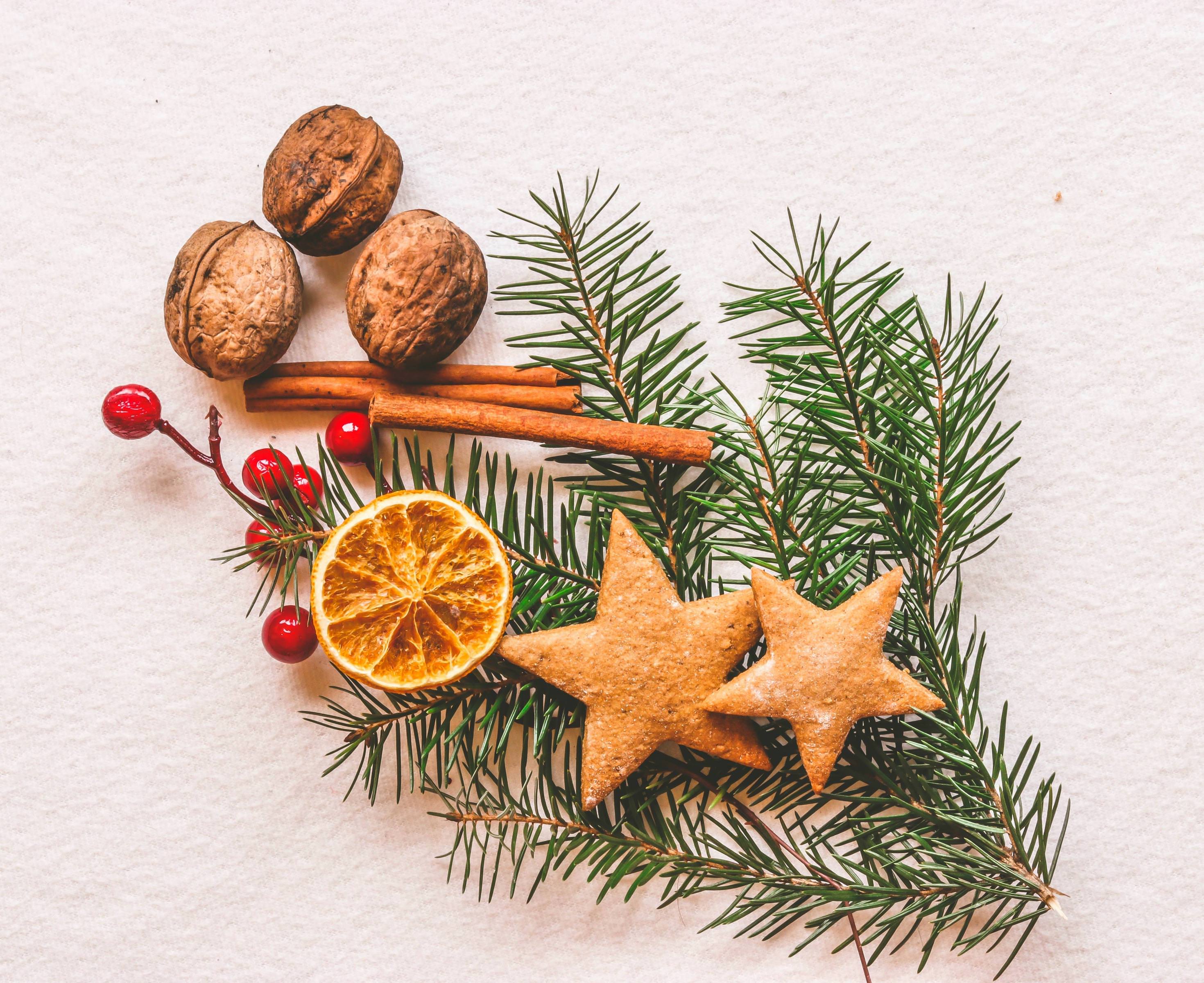 This photo of pine needles, cinnamon sticks, and other festive decorations makes for a great social media share in fall.