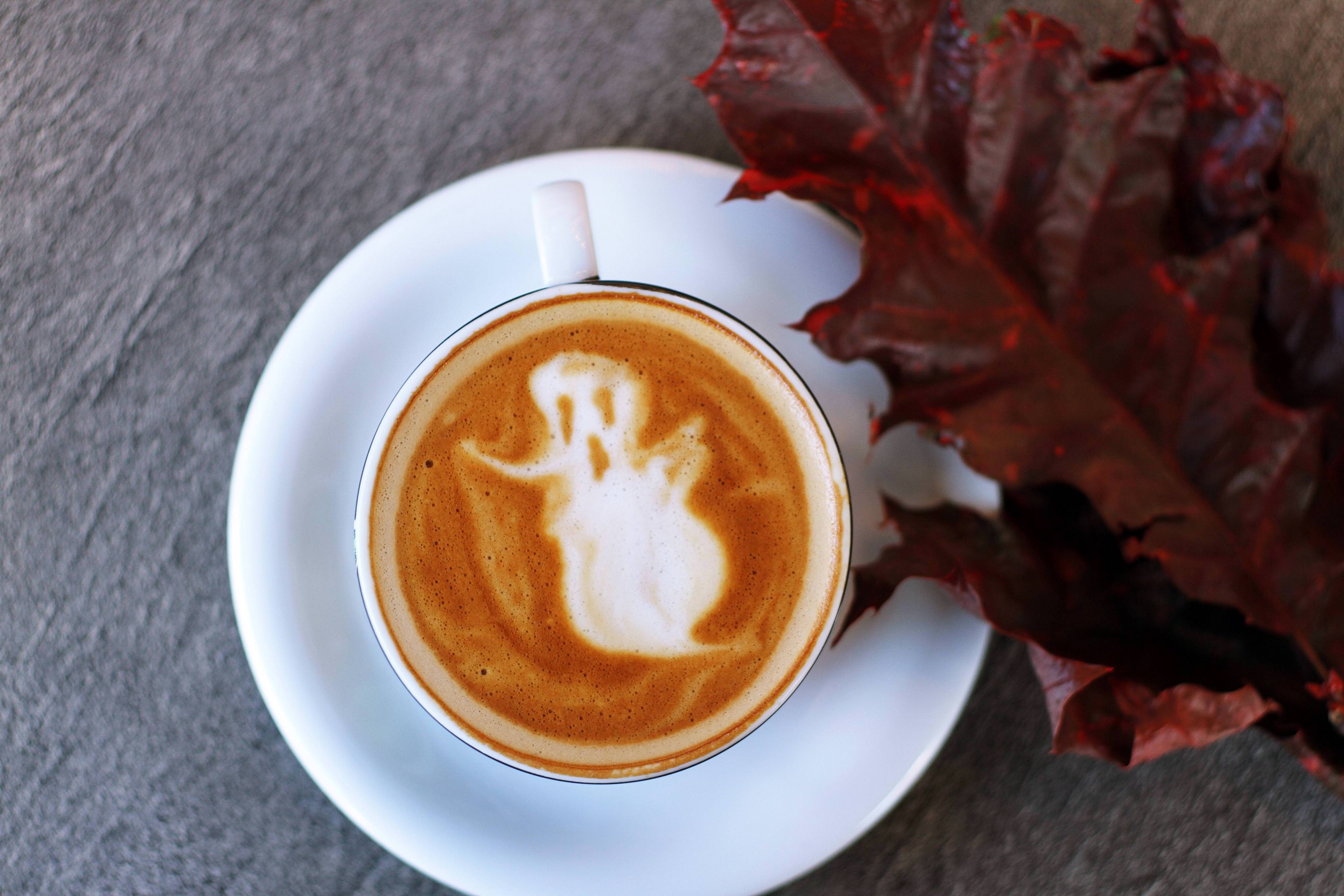 Cup of coffee with a ghost design on top, a perfect example of content for your fall social media