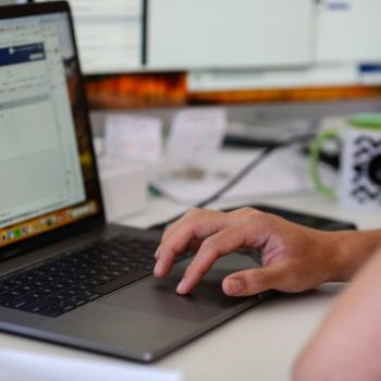 Julien Typing on a Laptop while Reviewing LinkedIn Ads 1600