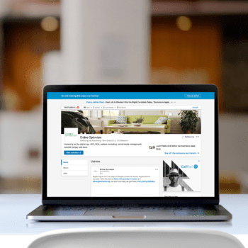 A laptop opened to a LinkedIn business page.