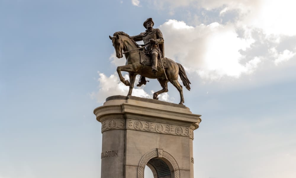 Statue of man riding atop a horse