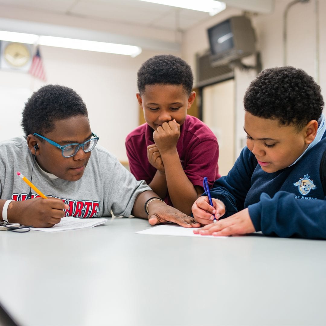 Three students doing work together