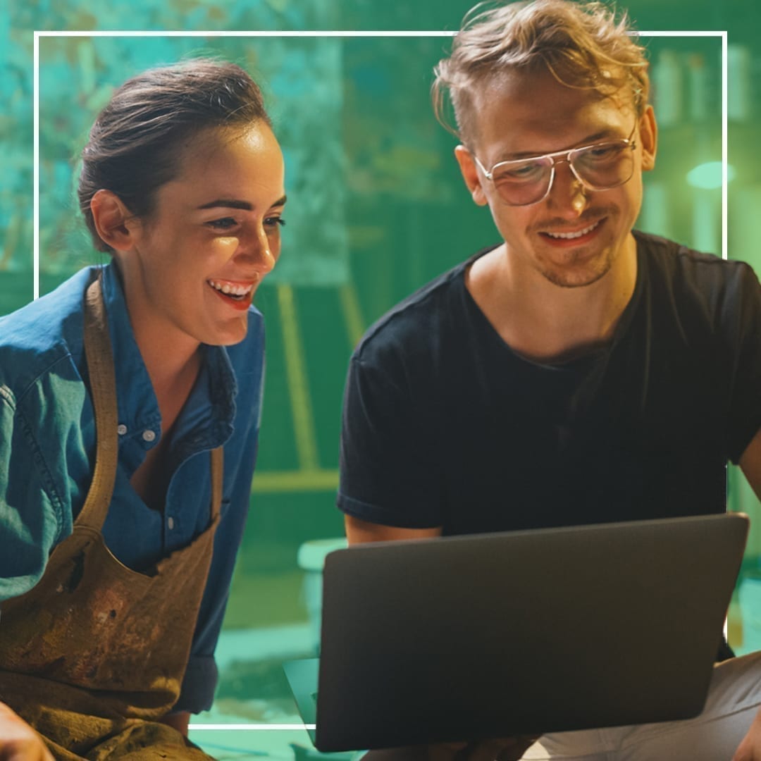 A man and woman working together on laptop