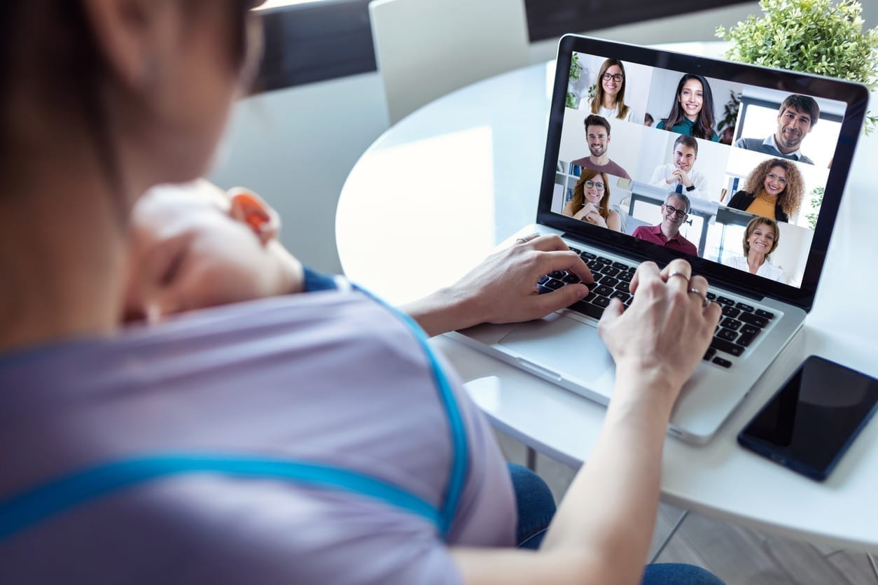 A woman on a video call learns to work from home with a baby