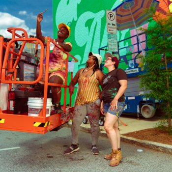 Living Walls nonprofit people taking a selfie in front of a mural