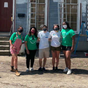 Online Optimism team volunteering to paint houses