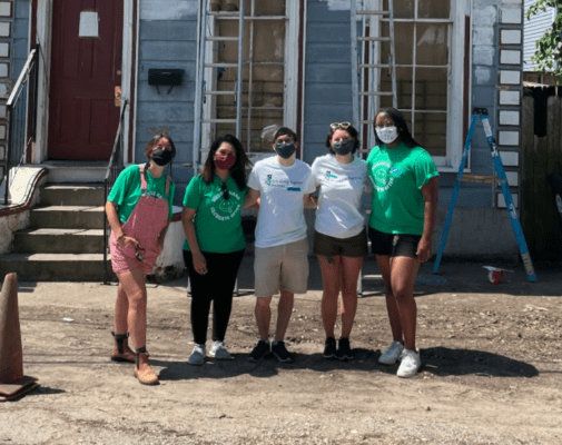 Online Optimism team volunteering to paint houses