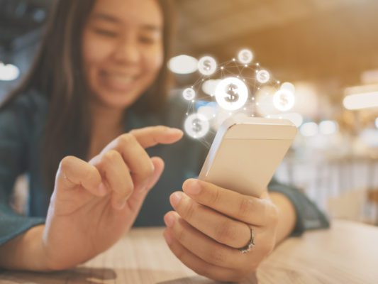 Woman hand using mobile phone with online transaction application