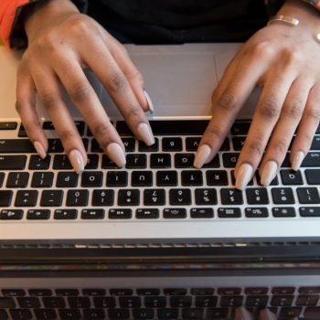 A women typing on a laptop