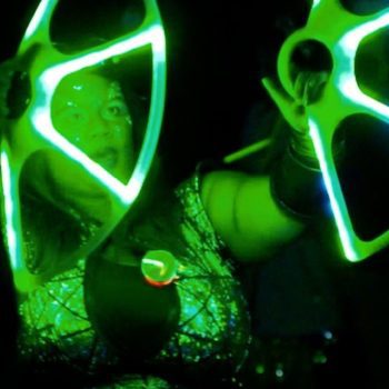 Mardi Gras parade performer with green neon lights