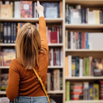 Woman picking out a book in a bookstore