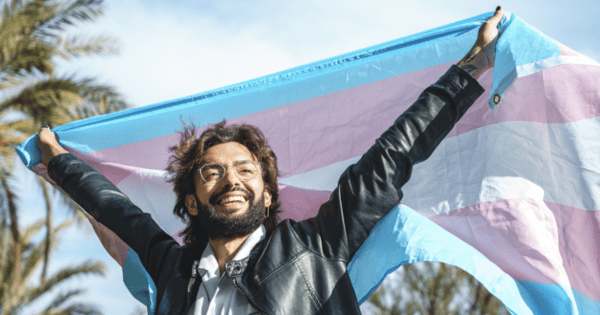Picture of a Man Smiling with Transgender Flag