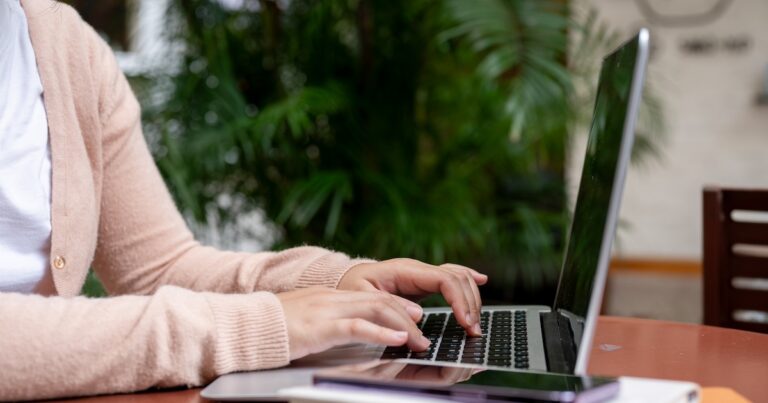 A photo of a person working on a laptop